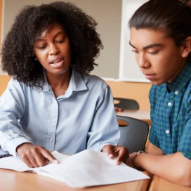 Teacher supporting a student with a classroom assignment